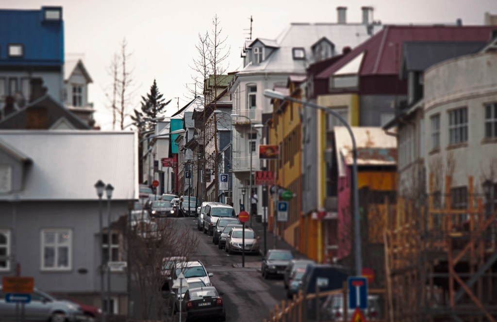 Reykjavik city streets. Iceland population hoovers around 320,000 while annual tourist visits pushes 800,000. This means travel and transportation within the city is phenomenally simplified. The bus terminal at KEF has convenient bus ticket kiosks and Flybus (a.k.a. Reykjavik Excursions ((same company))) leave for the city center a few times an hour. The bus terminal in the city center is within walking distance of most hotels--and door-to-door shuttle service is available for an extra 500ISK (1900 ISK vs. 2400 ISK). Canon T3i, 194mm, ISO 100, f/5.6, 1/100